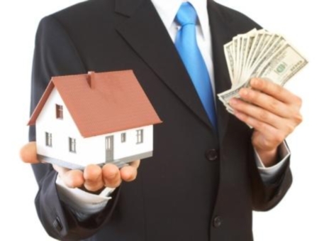 real estate concept with US dollars and mini house, shallow dof